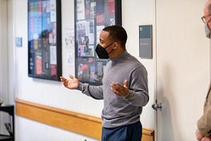 photo of student speaking in front of display