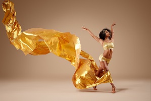 photo of dancer with long golden scarf
