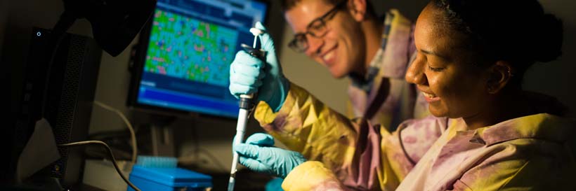 Jesmine Torres-Roberts and Curtis Kapsak in the DNA sequencer lab.