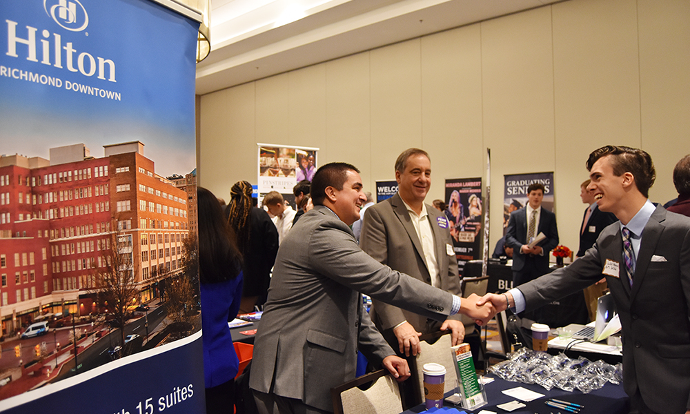 Representatives from Hilton talking with a student at the Fall Career Fair - 2019