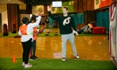 Hart School volunteer high-fiving a student during Qatar National Sports Day - 2019