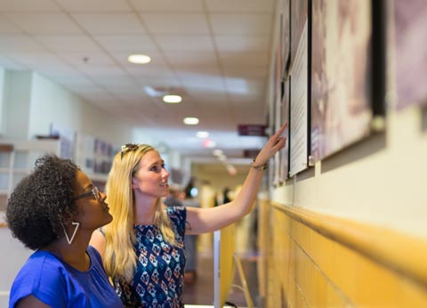 JMU students view a display panel at the Lucy Simms Exhibition