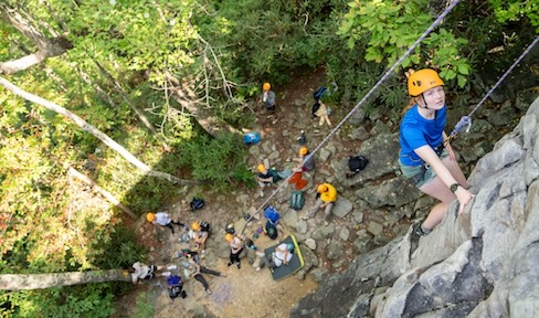 A JMU student rock climbing during a MOAT trip with peers.