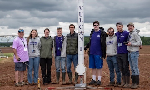 JMU Engineering students standing with their Vulcan I rocket.