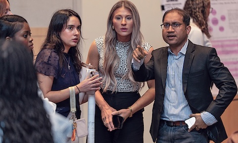Dr. Sojib Zaman talks with students in his Health Research Methods class during JMU's Spring 2025 Health Sciences Research Symposium.