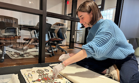 Anna Keath Smith (‘25) inspecting the condition of a headdress.