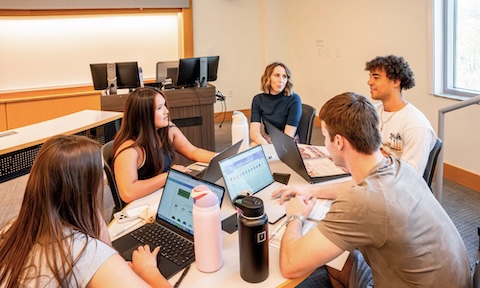 Students work on their IMC plans with the help of Dr. Kelly Naletelich, associate professor of marketing.