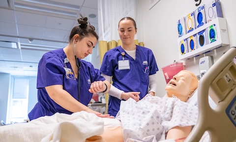 A photo of two nursing students working