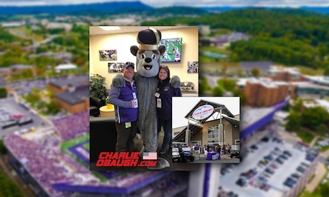 Eric and Jennifer Obaugh with Duke Dog, pictured against a backdrop of Bridgeforth Stadium and the Charlie Obaugh Auto Group Parking Deck.