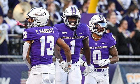 Three football players smiling