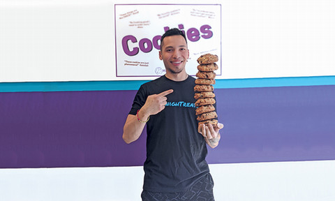 Man holding a stack of cookies