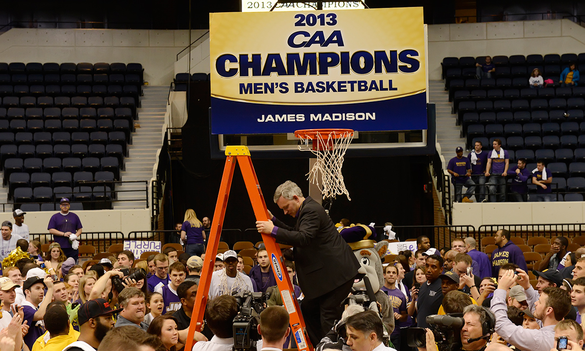 ...helping to cut down the net at the Richmond Coliseum after the team's Colonial Athletic Association championship victory.