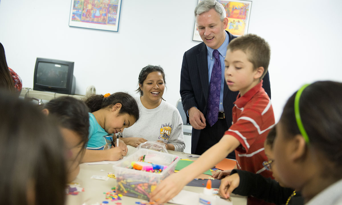 Mr. Alger joins a JMU student volunteer and kids at Second Home in making cards for troops in Afghanistan during JMU's Day of Service.