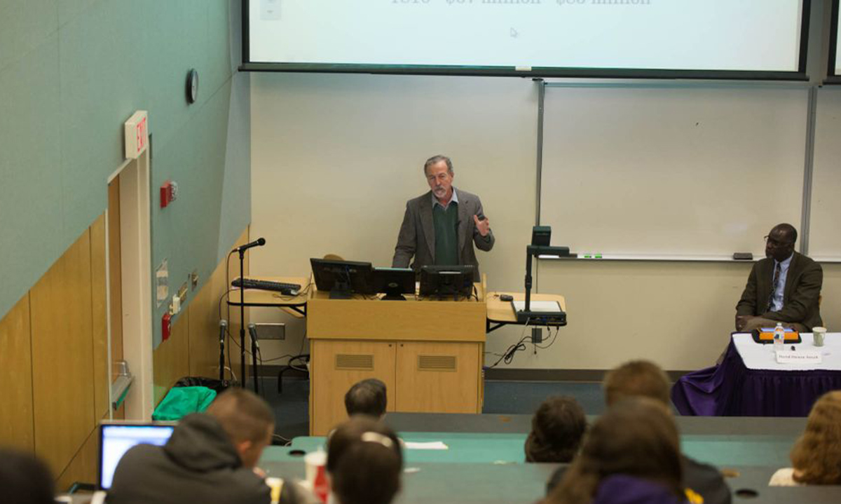 Faculty roundtable presenter Dr. Bruce Brunton of economics explains the background on the huge revenue and military problems President James Madison inherited upon taking office. 