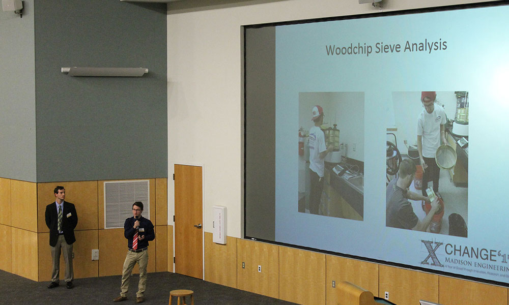 students discuss vdot wall project while showing slide on screen.