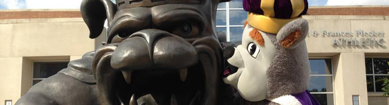 JMU's mascot Duke Dog kissing the Duke Dog statue by Bridgeforth Stadium