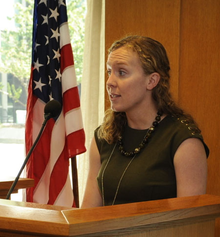 Katie Smith speaks from behind a podium.