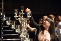 Student lighting candle at MLK formal program