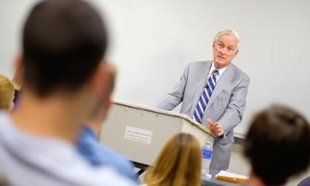 Dick Roberts speaks to students