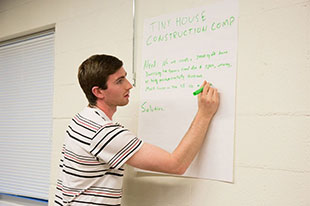 James Rollin works on presenting his idea for Tiny Town Construction.