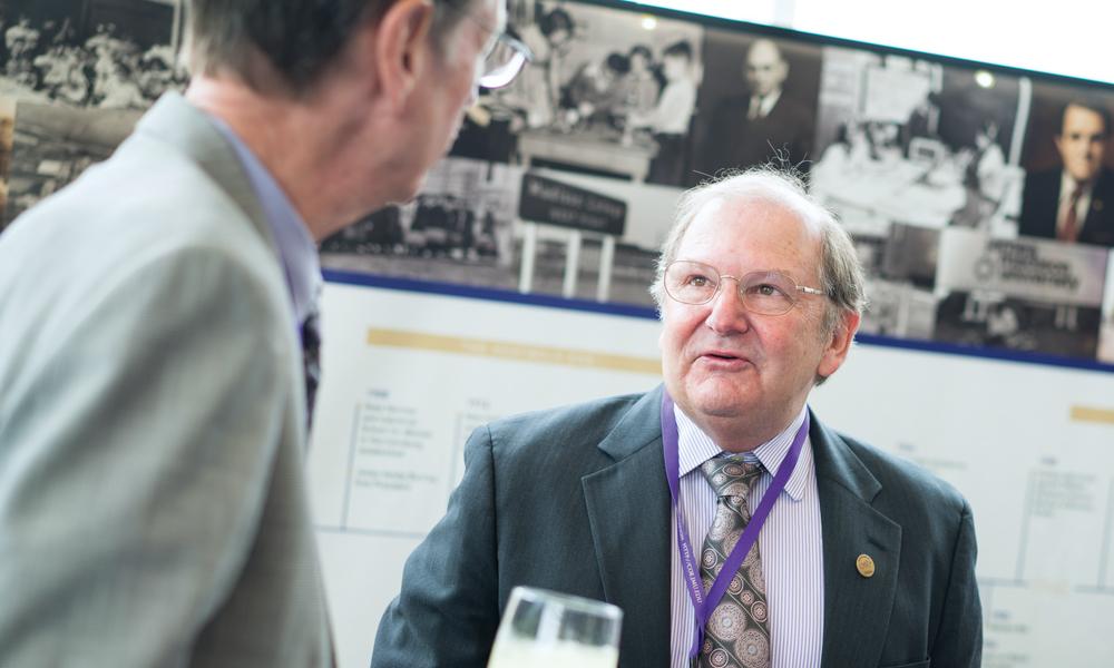 Jerry Benson and Phil Bigler chat at a reception in the East Campus Dining Hall.