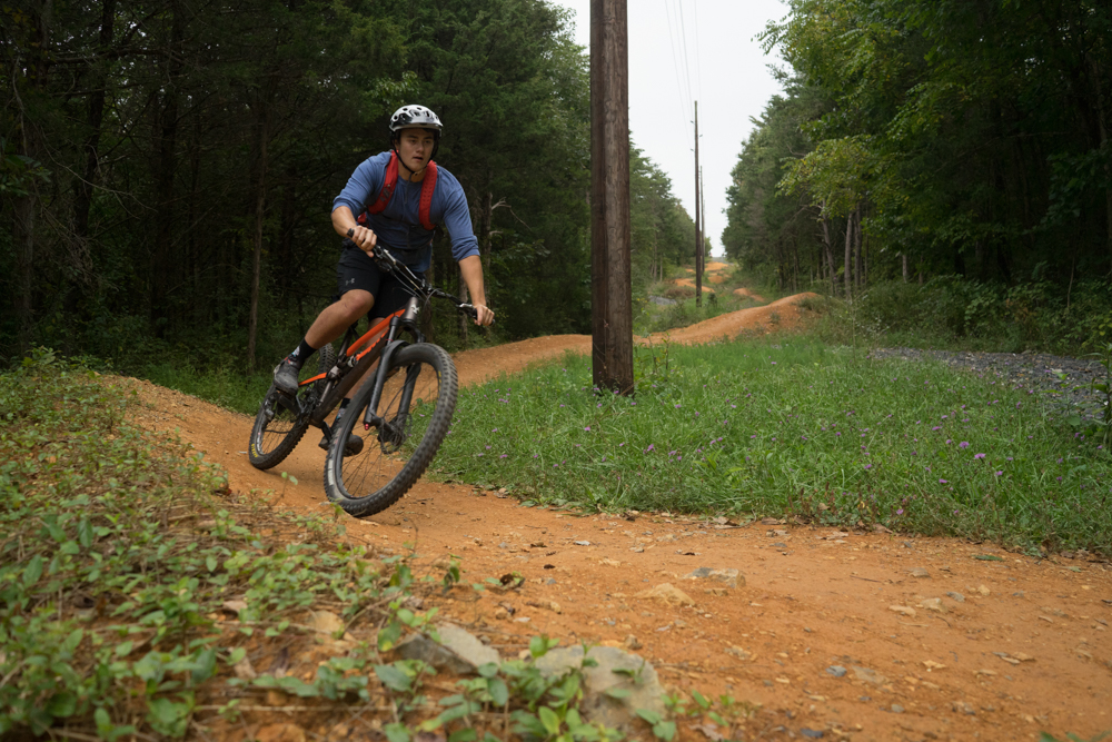 a mountainbiker riding down a trail at hillandale park