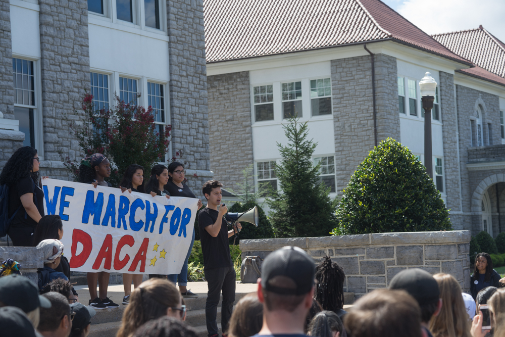 Students gathered outside of Wilson holding a 