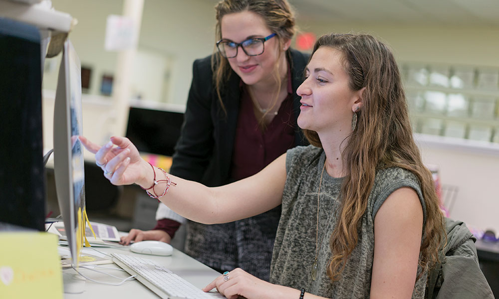 Rachel Petty works at The Breeze with a team member.