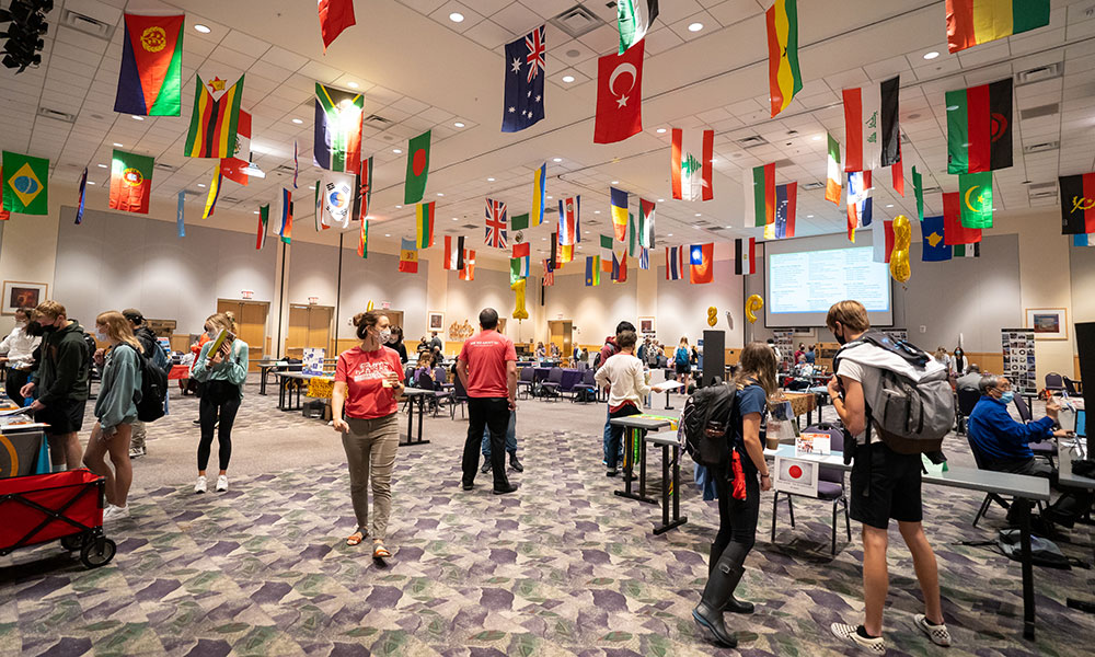 A room with tables and flags for the study abroad fair