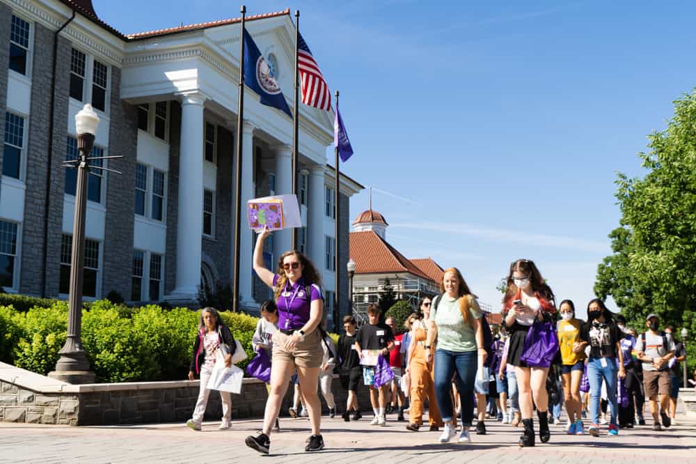 First year summer spring board leaders walking in front of wilson hall