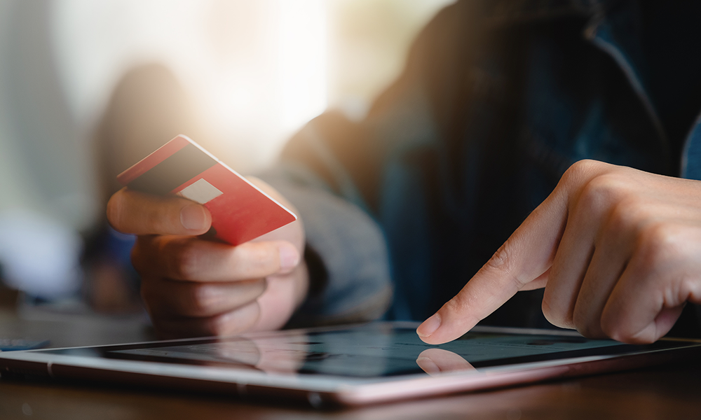 Stock image of a person holding their credit card.. 