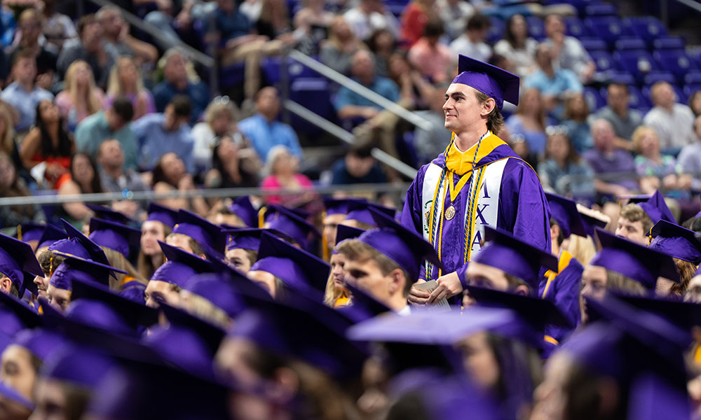 graduate standing among fellow graduates seated