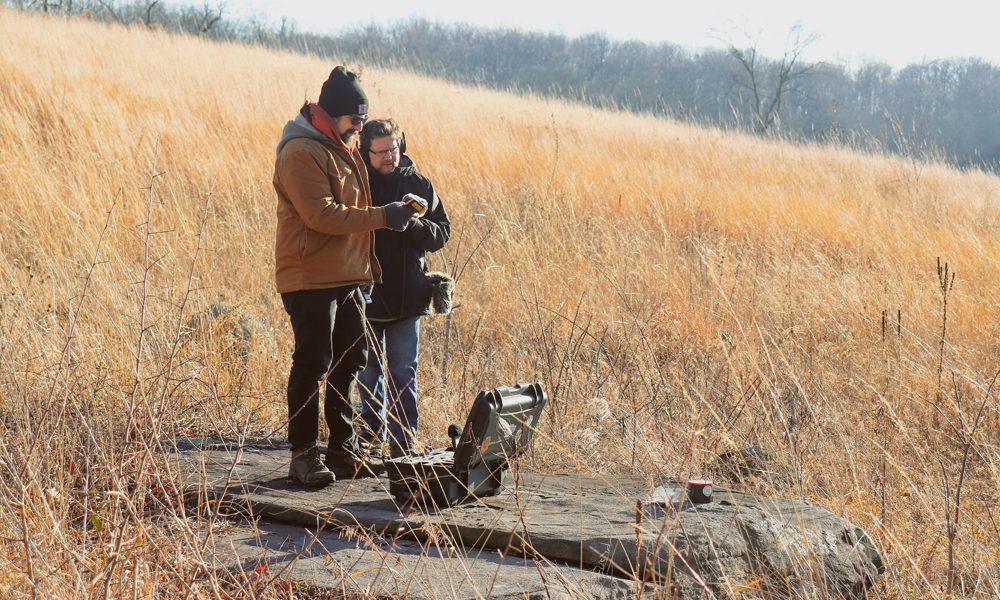 Tee Morris (’92) and Phil Rossi (’01) are pictured in a field.