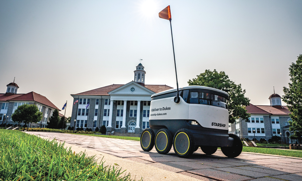 A Starship Technologies self-driving robot delivers food on the Quad.