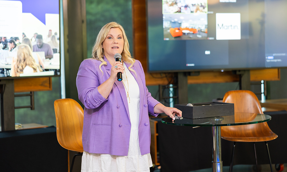 Chief Strategy Officer Elizabeth Paul (’03) speaks to the agency during a staff meeting.