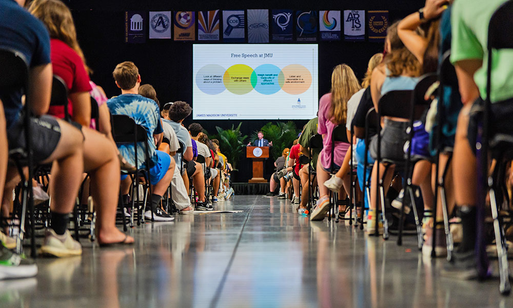 Students listen to a talk in an arena