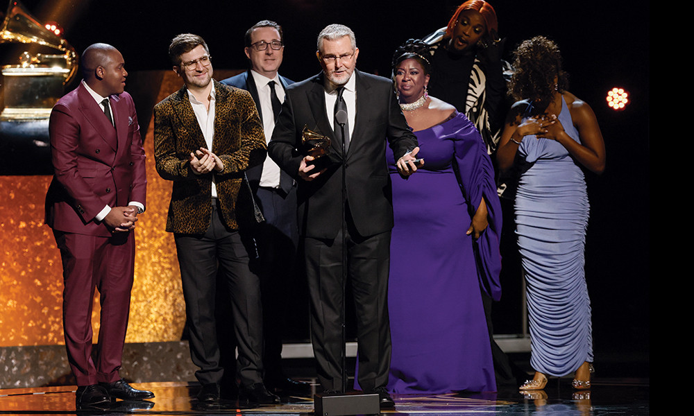 Music producer Scott M. Riesett ('93), center, accepts a Grammy for Musical Theater Album at the 66th Grammy Awards in Los Angeles, California, on Feb. 4, 2024, alongside others from the cast and crew of the musical “Some Like It Hot” on Broadway. Also pictured are orchestrators Bryan Carter and Charlie Rosen (first and second from left) and cast members Natasha Yvette Williams, J. Harrison Ghee and Adrianna Hicks (third, second and first from right). Photograph by Robert Gauthier/Los Angeles Times via Getty Images