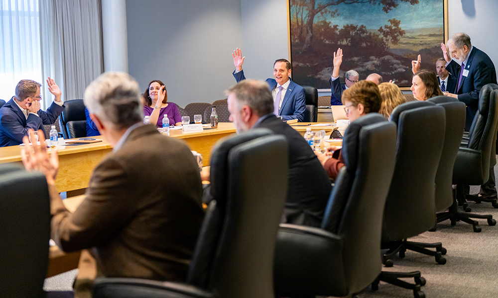 Donors talking around the boardroom table.