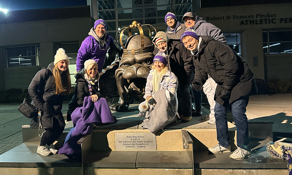 Mauck family posing by duke dog statue
