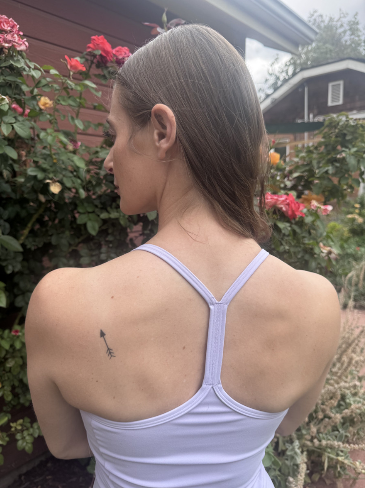 Jamie McGaha’s arrow tattoo is shown on her back