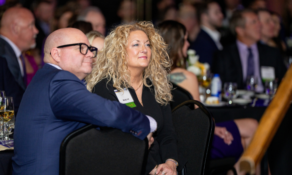 Alumni captured at their table engaged in the program