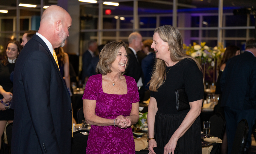 A candid of event attendees chatting with each other 