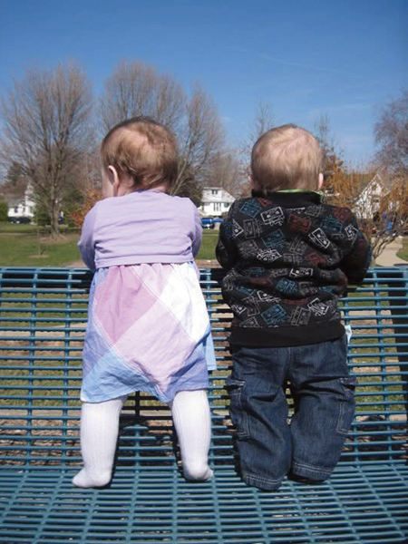 Dr. Jennifer Rosier's twins standing on a park bench