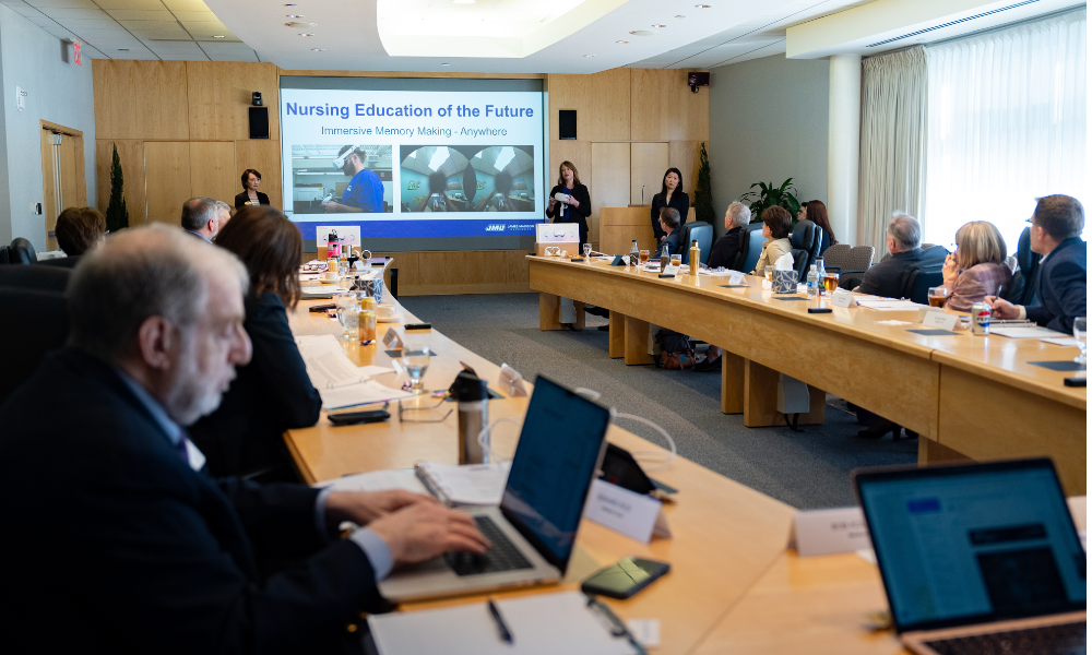 Rice takes notes as JMU faculty presents in Madison Trust boardroom