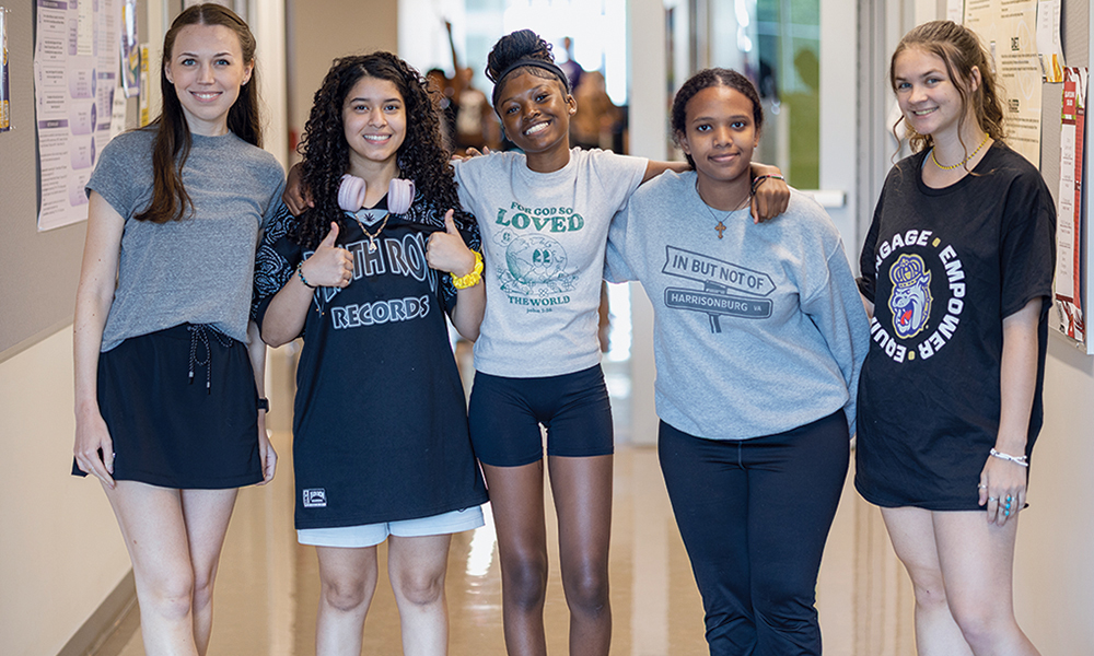 Headstrong campers are smiling in a group photo with JMU students