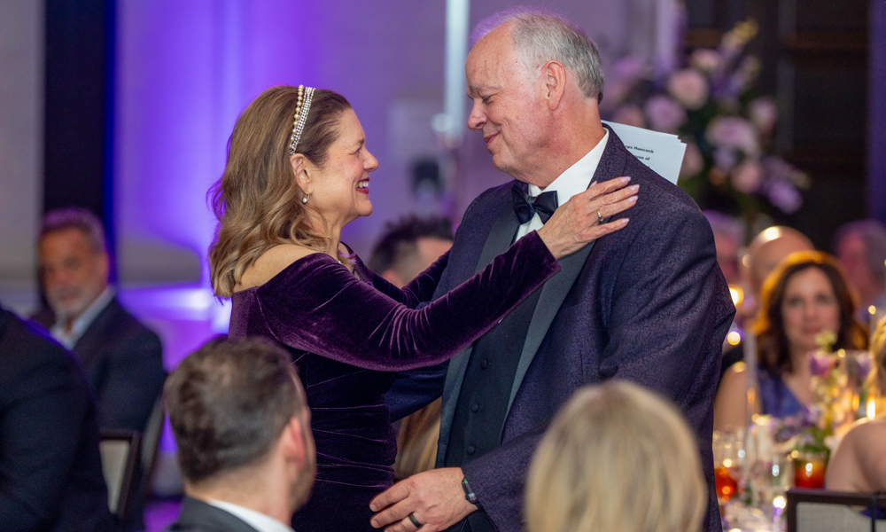 First lady Kim Schmidt leans in to embrace her husband, Dr. James C. Schmidt, president of JMU
