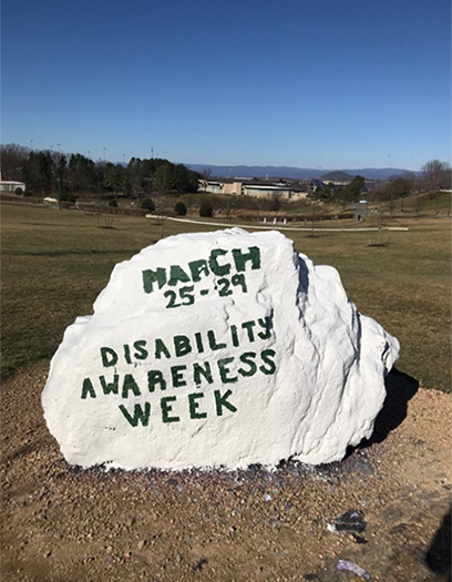 JMU Spirit rock shown from an angle with words: March 25-29 Disability Awareness Week