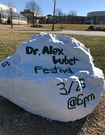 JMU Spirit rock shown from an angle with words: Dr. Alex Lubet Festival 3/29 at 6pm