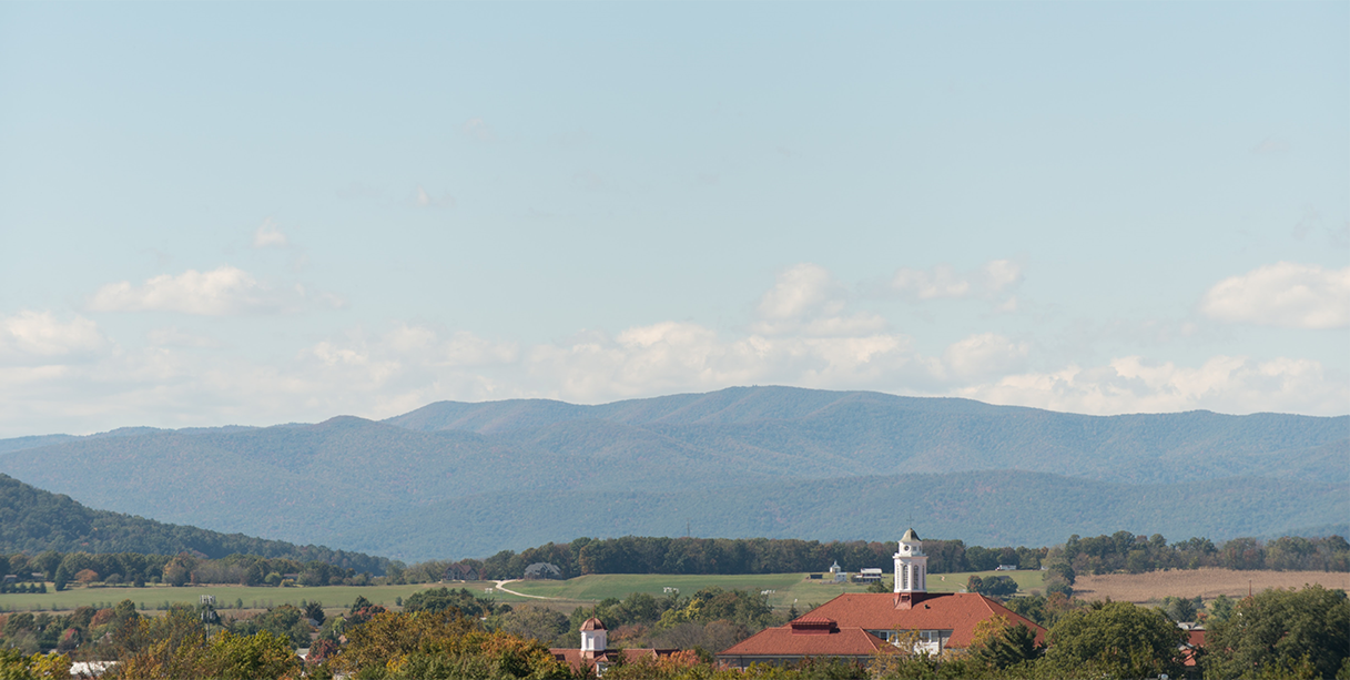 A view of Wilson Hall with the mountains in the background