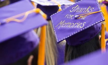 the tops of grad caps are in focus with one saying thanks for the memories
